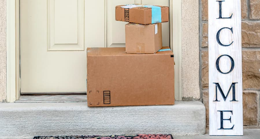 Boxes by the door of a residence with a welcome sign in Duluth